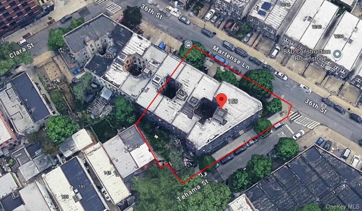 Aerial view of property and surrounding area with property parcel outlined