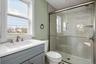 Bathroom featuring a shower stall and vanity
