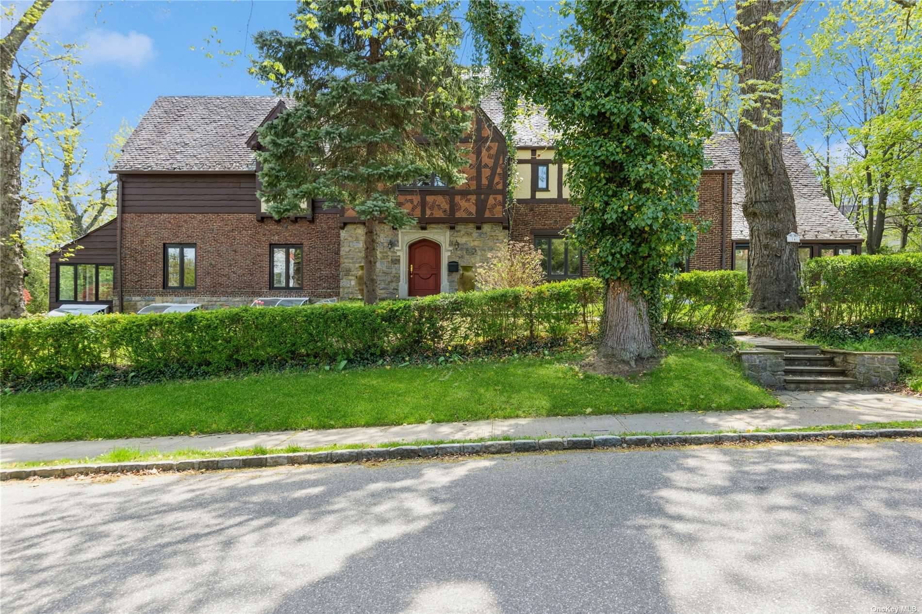 Welcome to this spectacular Tudor home boasting six bedrooms and four full bathrooms with 3 half baths.