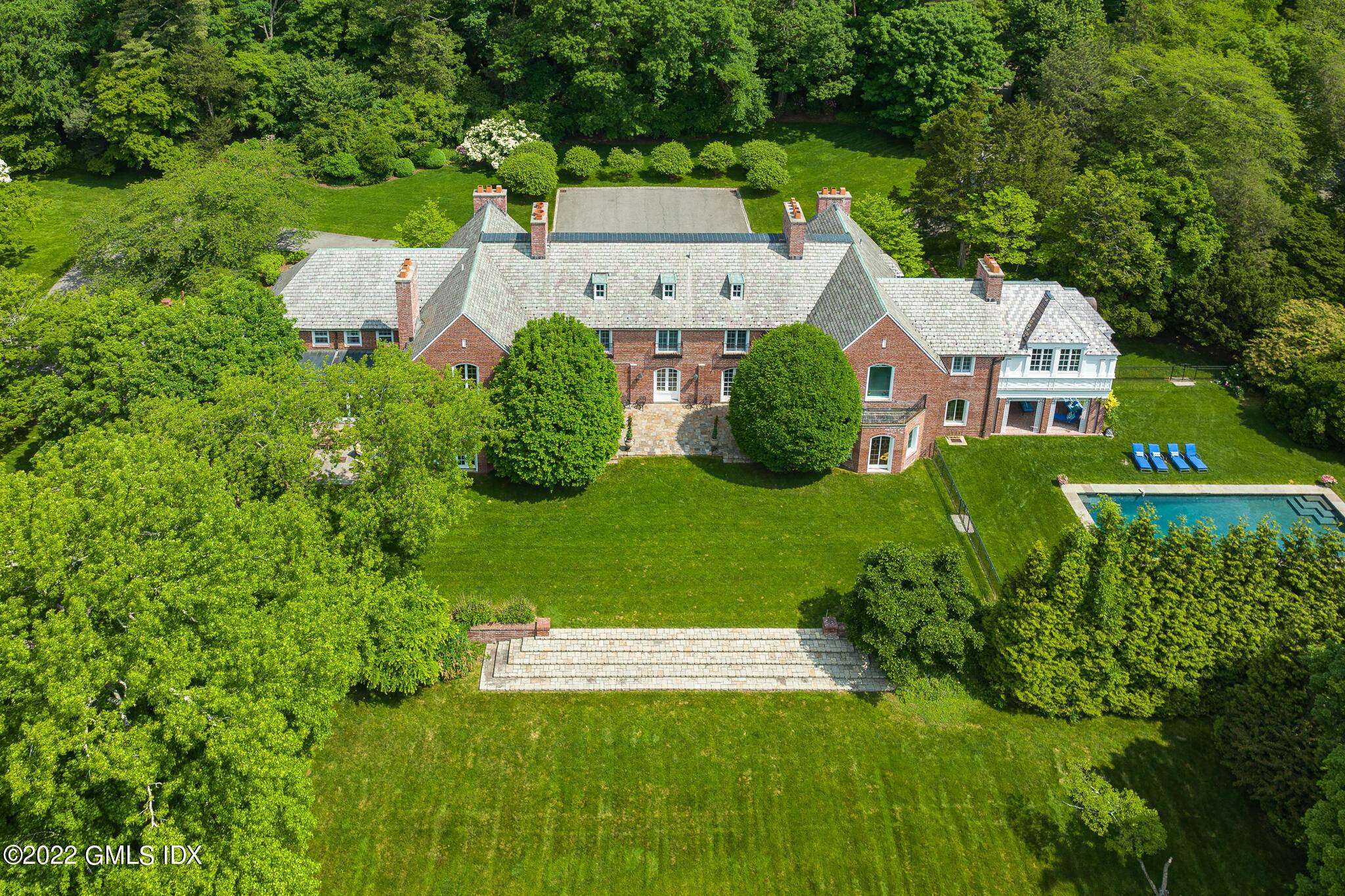Grahampton, one of the last original Great Estates remaining in Greenwich, comprises five beautifully landscaped, gated acres with a pool in the heart of Mid Country.