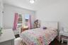 Bedroom with hardwood floors and oversized window (#222)