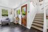 Foyer featuring stairway and dark wood finished floors