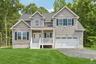 Beautiful colonial home. Lawn is an AI-generated rendering.