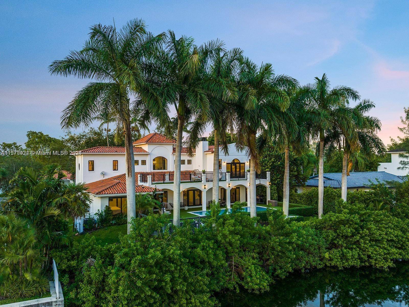 Stunning two story residence situated along the canal in the prestigious guard gated community of Gables by the Sea.