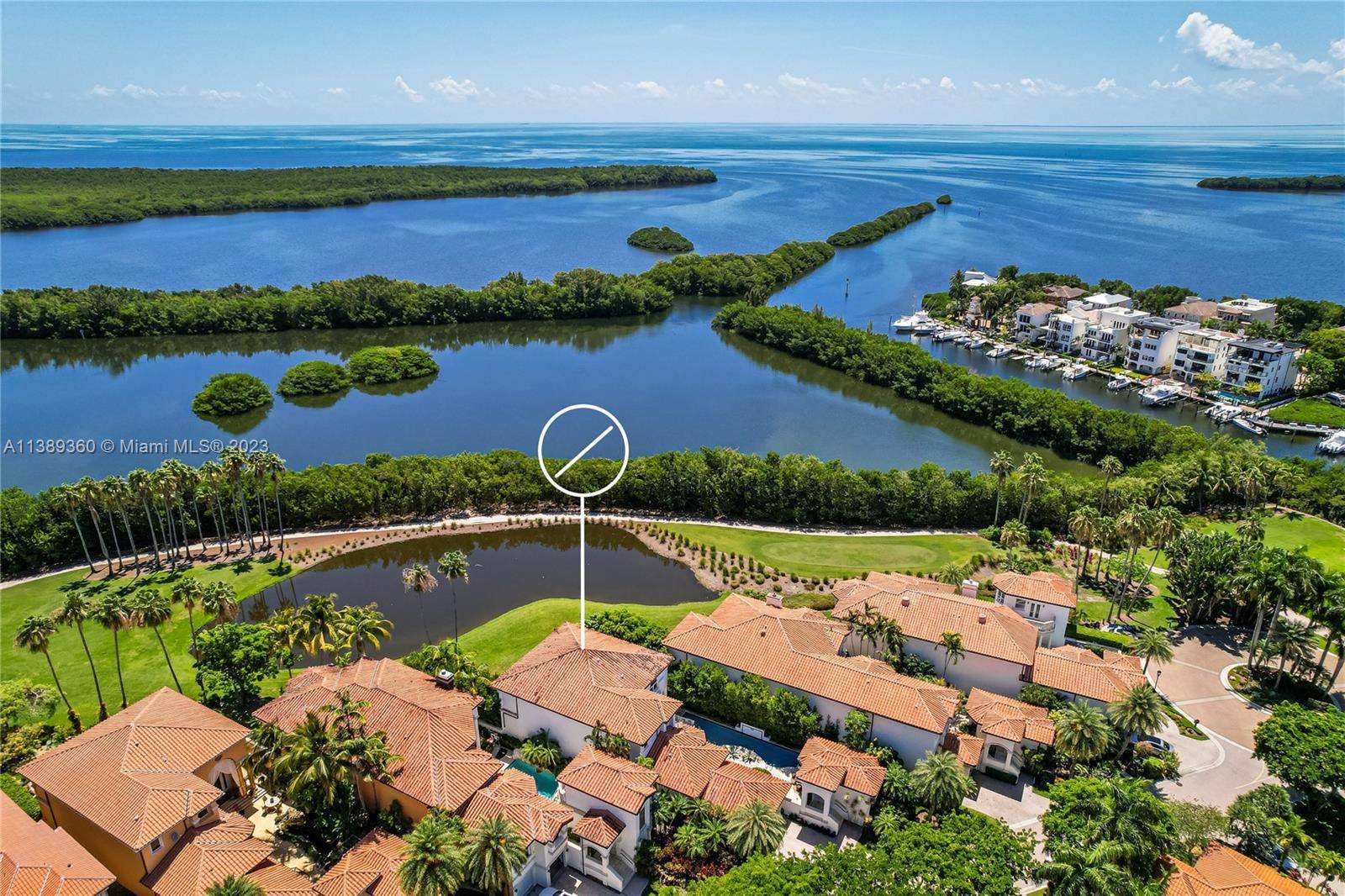 Exquisite 4b 5. 5b estate with a separate guest house overlooks the greens of the Deering Bay Golf Course.
