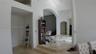 View from the Formal Dining Room towards the Kitchen (1st opening), formal Living Room and beyond to the office and Master Bedroom.