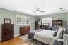 Bedroom #3 featuring customed closet and natural wood floors.