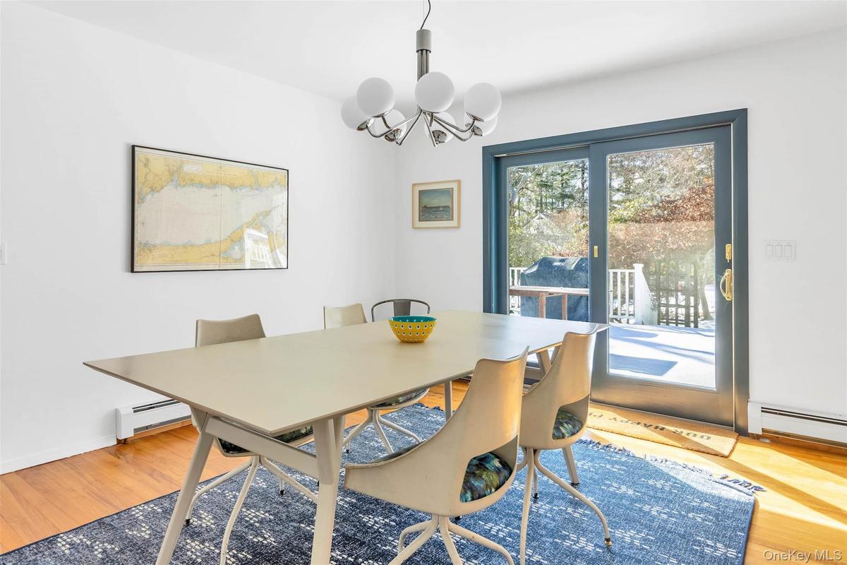 Dining room featuring a chandelier, hardwood / wood-style floors, and baseboard heating