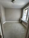 Empty room with radiator and baseboards