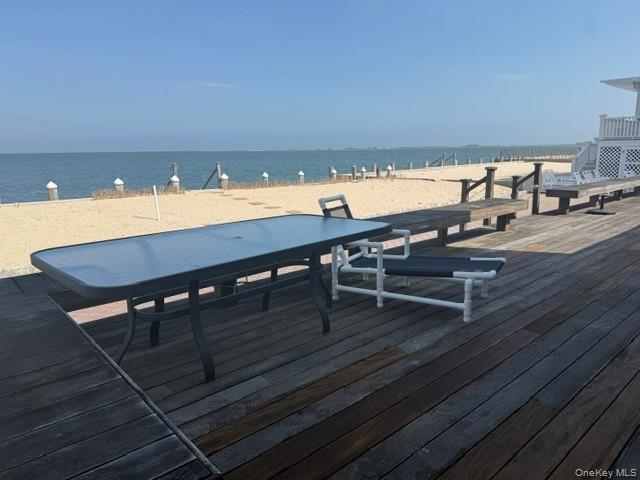 Deck featuring a beach view and a water view