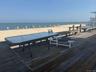 Deck featuring a beach view and a water view