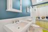Full bathroom featuring toilet, shower / bath combo with shower curtain, and sink