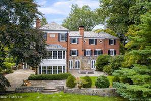 A long gated drive approaches the brick stone English Manor originally built for a 1930's heiress.