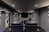 Home theater room featuring crown molding, recessed lighting, and carpet floors