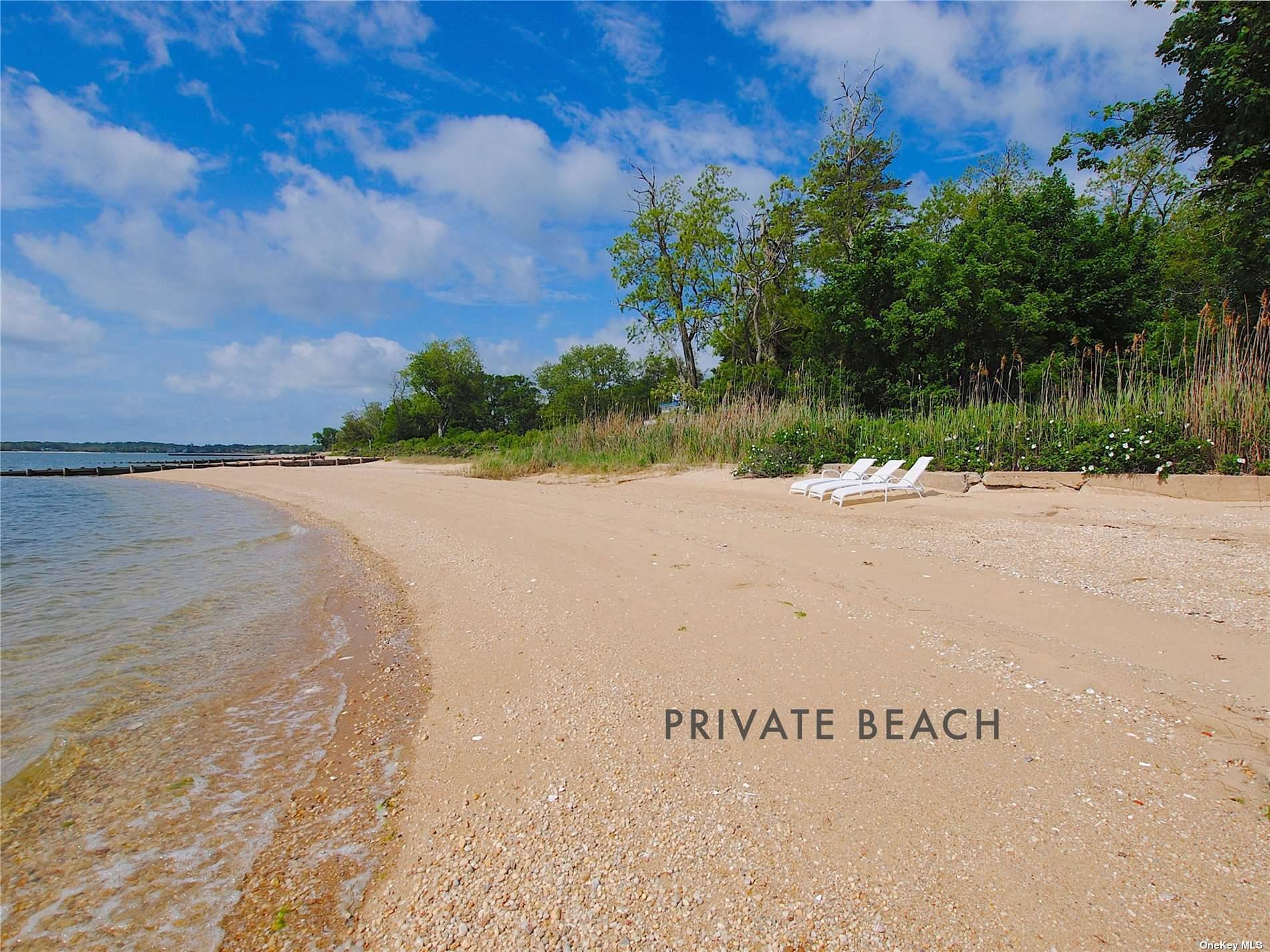 Quintessential waterfront North Fork farmhouse with private sandy beach on Southold Bay, part of the Peconic Estuary.