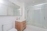 Bathroom with vanity, combined bath / shower with glass door, tile walls, light tile patterned floors, and recessed lighting