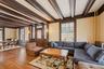 Living room with beam ceiling, hardwood / wood-style flooring, and crown molding