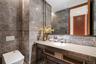 Bathroom featuring decorative backsplash, toilet, tile walls, and vanity