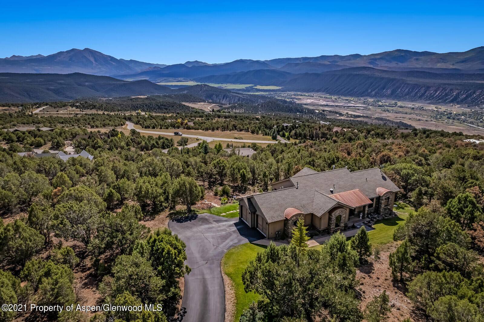 This quintessential mountain home in Elk Springs has unobstructed hilltop views of Mt.