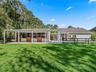 Well-appointed horse barn with spacious stalls just steps from the main residence.