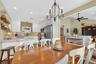 Dining area with lofted ceiling, ceiling fan, a chandelier, and recessed lighting