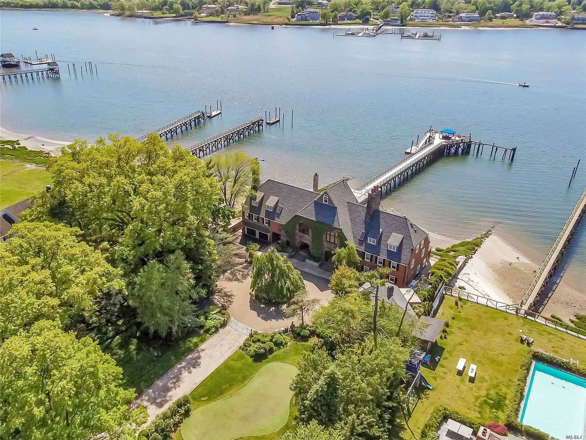 MANHASSET. Tucked Away On A Quiet Waterfront Road in Plandome Manor, A Rare Opportunity Awaits For You To Own A Magnificent Piece Of Local History.
