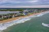This expansive coastal view looks north along the beach, showcasing the quiet, residential stretch of New Smyrna’s no-drive zone.