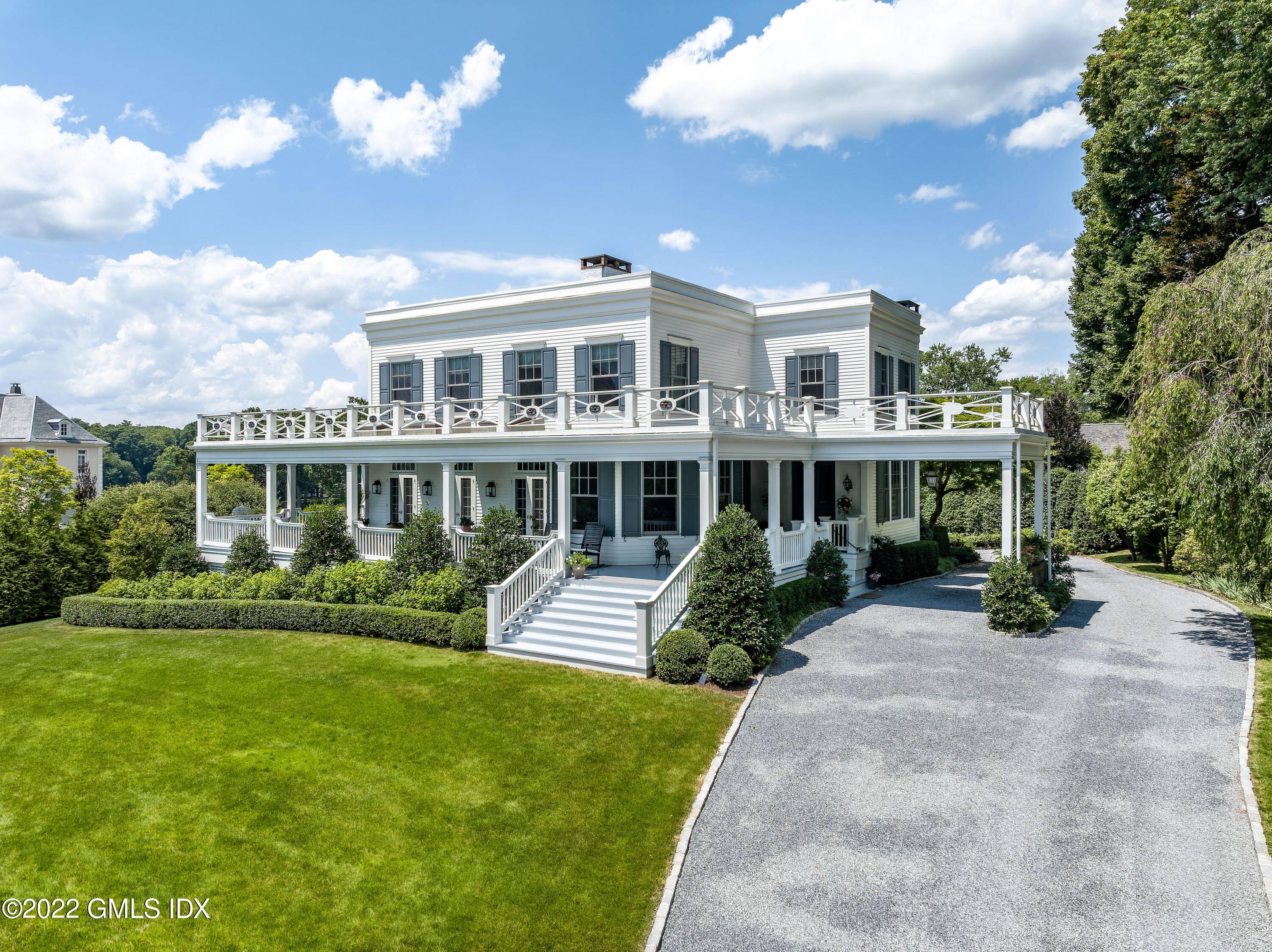 In the heart of the Belle Haven Association, a traditional Federal Colonial Revival is situated on a secluded lane with water views over Byram Harbor.