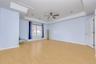 Master Bedroom with a raised ceiling, light wood finished floors, crown molding, and a ceiling fan