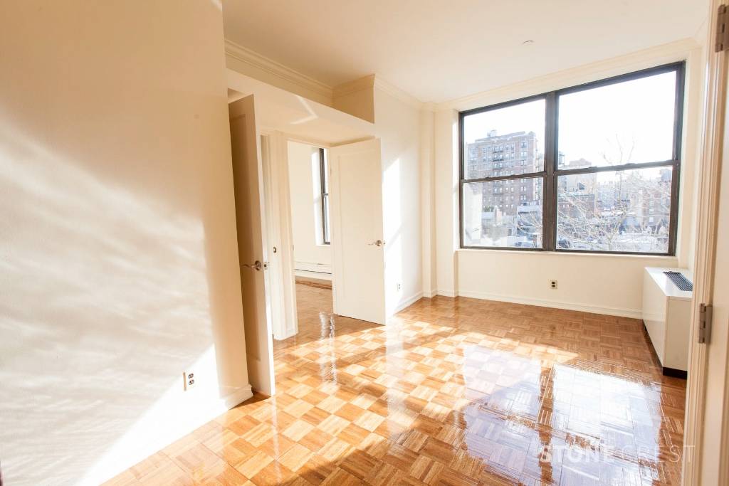 A two bedroom apartment with Central Air in a luxury doorman building with a roof deck and laundry room.