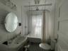 Bathroom featuring toilet and shower / tub combo