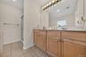 A wall of vanities, double sinks and cabinets!
