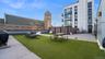 View of community featuring a patio area, a lawn, and an outdoor hangout area