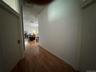 Hallway featuring dark wood-style flooring and track lighting