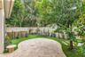 Backyard oasis- easy maintenance turf, Travertine pavers, covered porch and new white vinyl fence