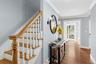 Front entry featuring wood finished floors and ornamental molding