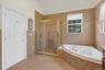 Tile flooring with a coordinating tile shower surround and tub deck