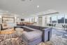 Living area featuring a raised ceiling and recessed lighting