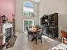 Stunning open-plan formal dining room with approx 20'+ ceiling, arched window, slider to the private deck.