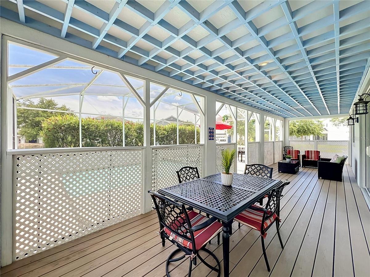 Covered lanai with upgraded wood flooring / wood ceiling accents.