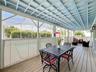Covered lanai with upgraded wood flooring / wood ceiling accents.