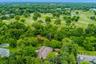 Beyond the property's wooded borders lies Fenway Golf Club, providing a remarkable backdrop and enhancing the home's exceptional privacy.