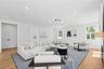 Living area featuring light wood-style floors, recessed lighting, and a fireplace