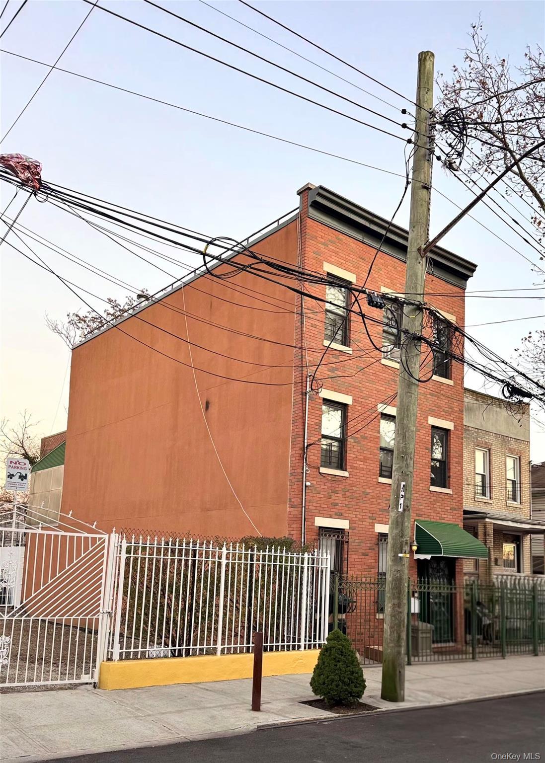 View of building exterior featuring a fenced front yard