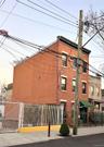 View of building exterior featuring a fenced front yard