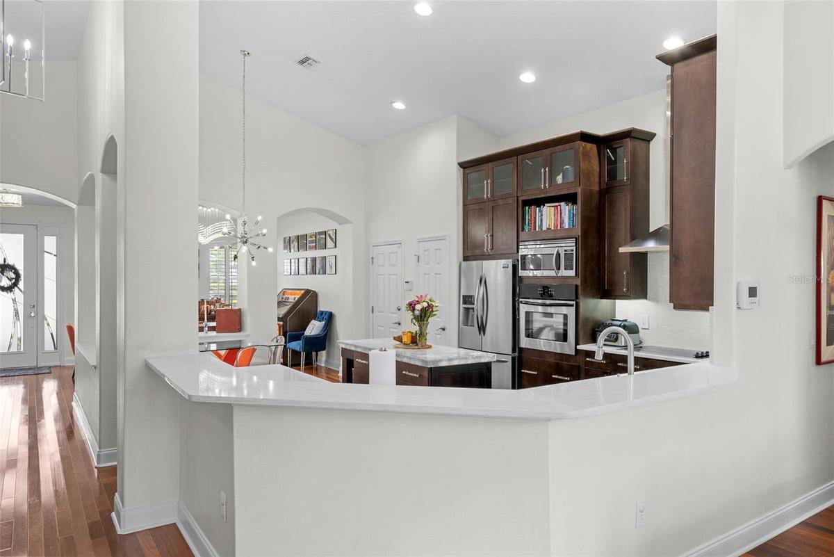 Kitchen pass-through with open sightlines to the living spaces.