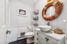 Bathroom with dark wood-type flooring, vanity, a wainscoted wall, a baseboard heating unit, and ornamental molding