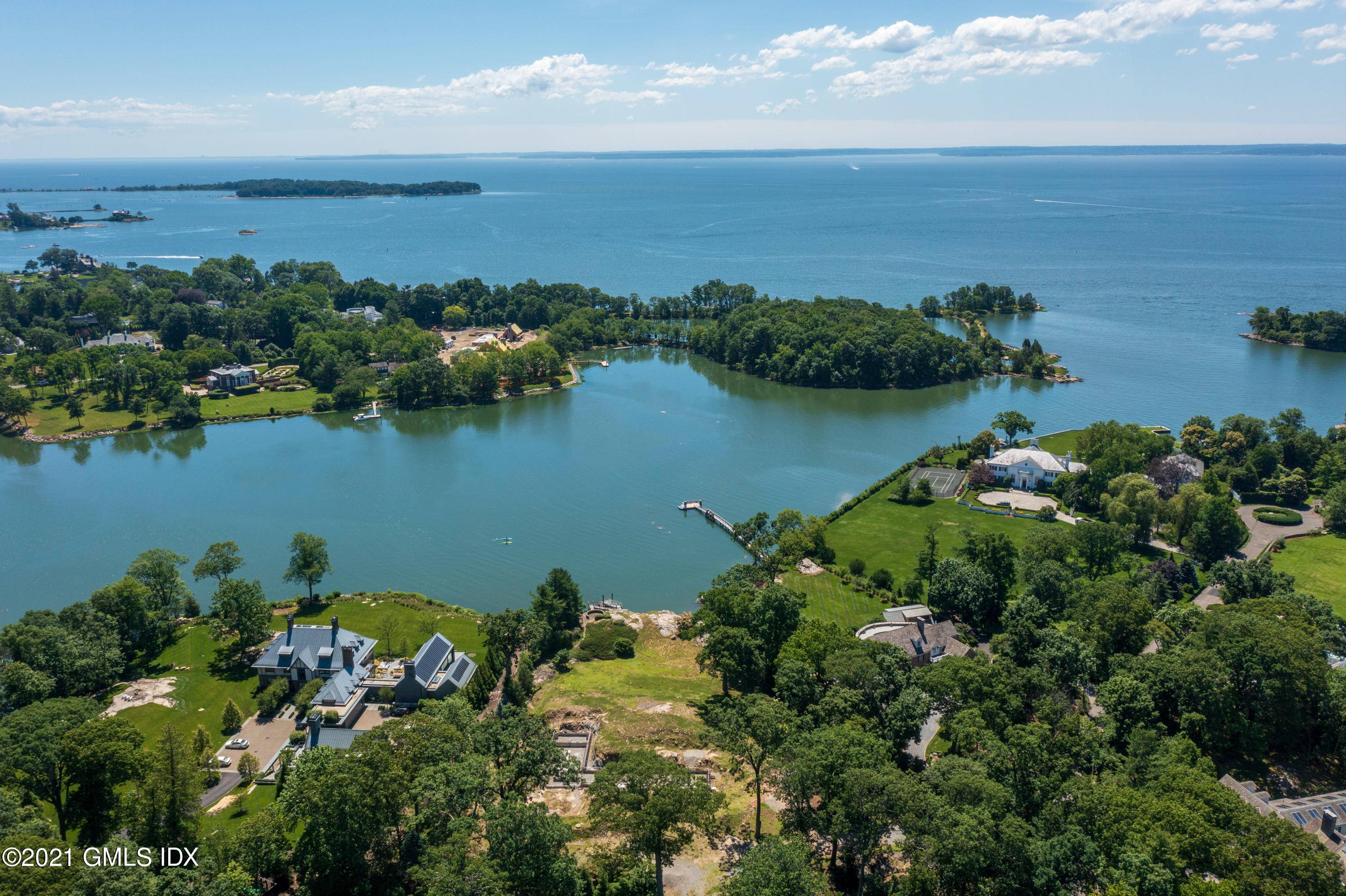 Idyllic 3 acre waterfront lot with private dock captures spectacular views from a promontory overlooking Indian Harbor.