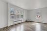 Spare room with radiator heating unit and wood finished floors