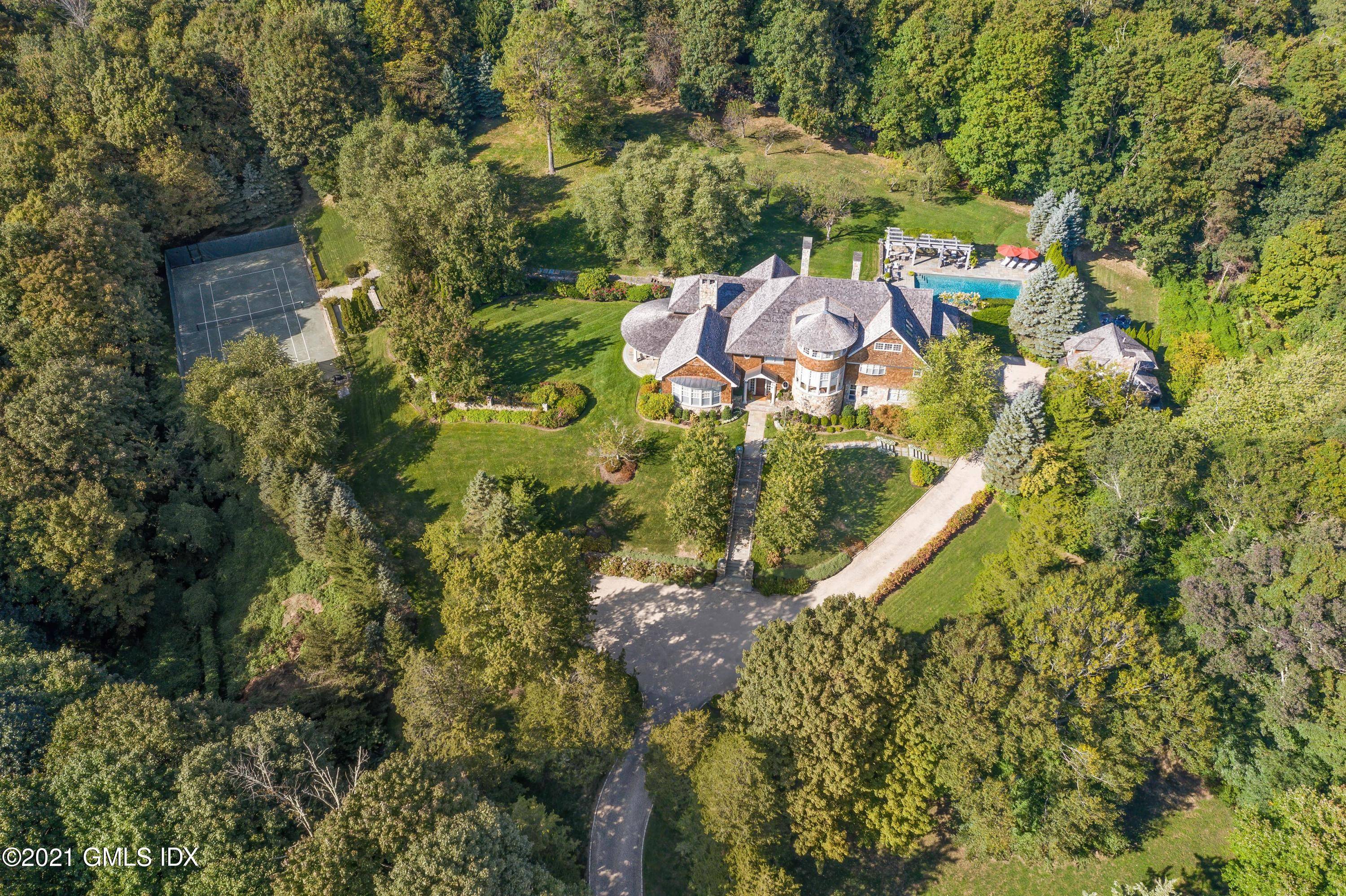 Beautiful private compound on over six lush acres with mature, William Rutherford, designed gardens.